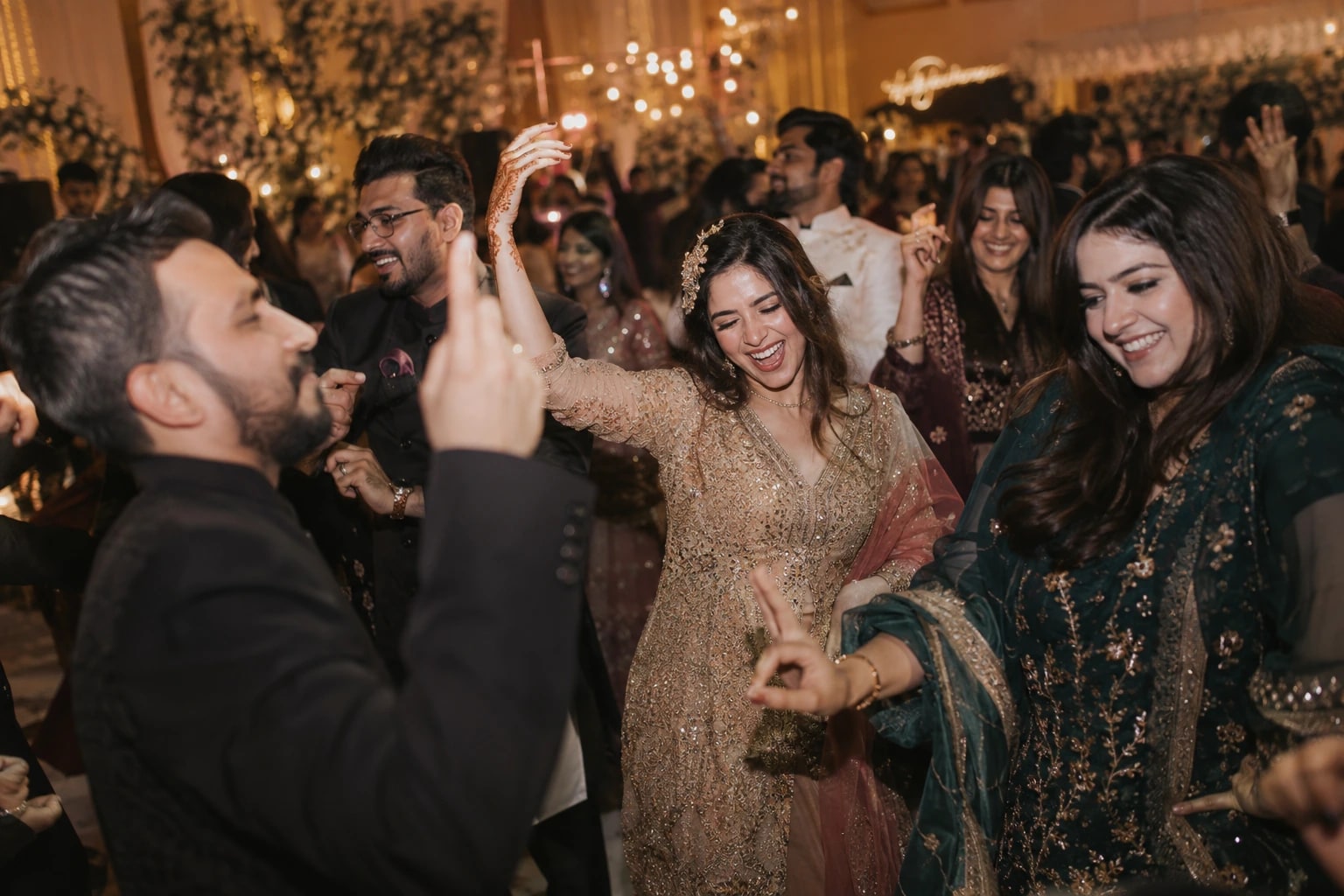 Guests dancing together at an evening wedding reception
